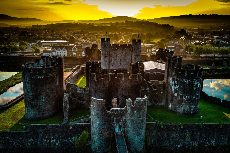 Aerial photograph of stone fortifications and a moat at a heritage site in Caerphilly.