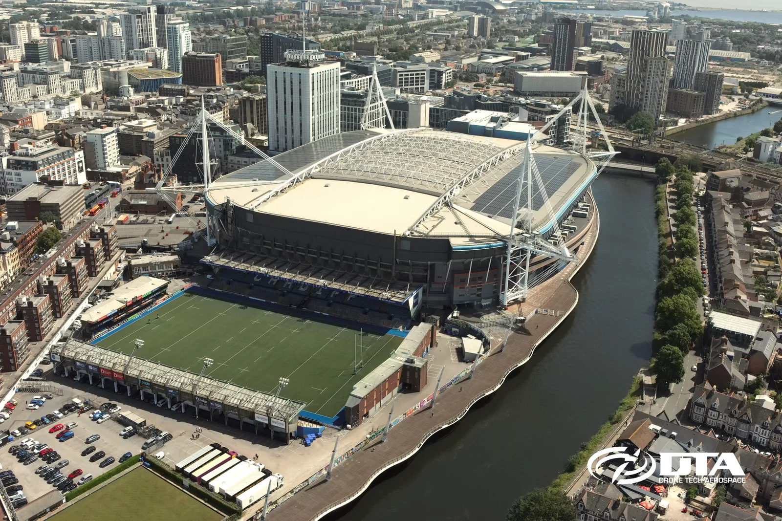 Aerial photograph of a rugby stadium pitch and stands beside the River Taff in Cardiff.