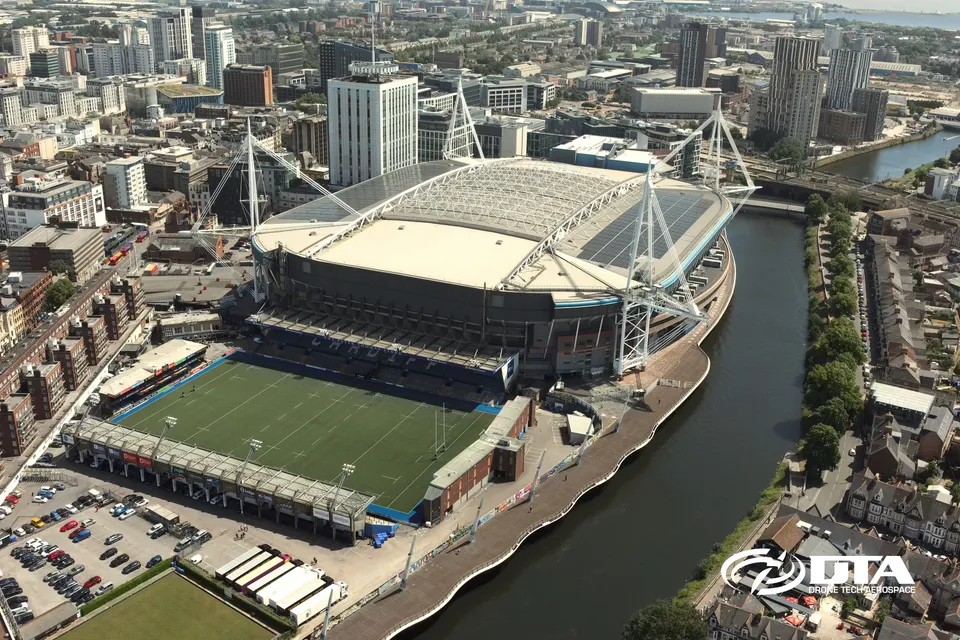 Aerial photograph of a rugby stadium pitch and stands beside the River Taff in Cardiff.