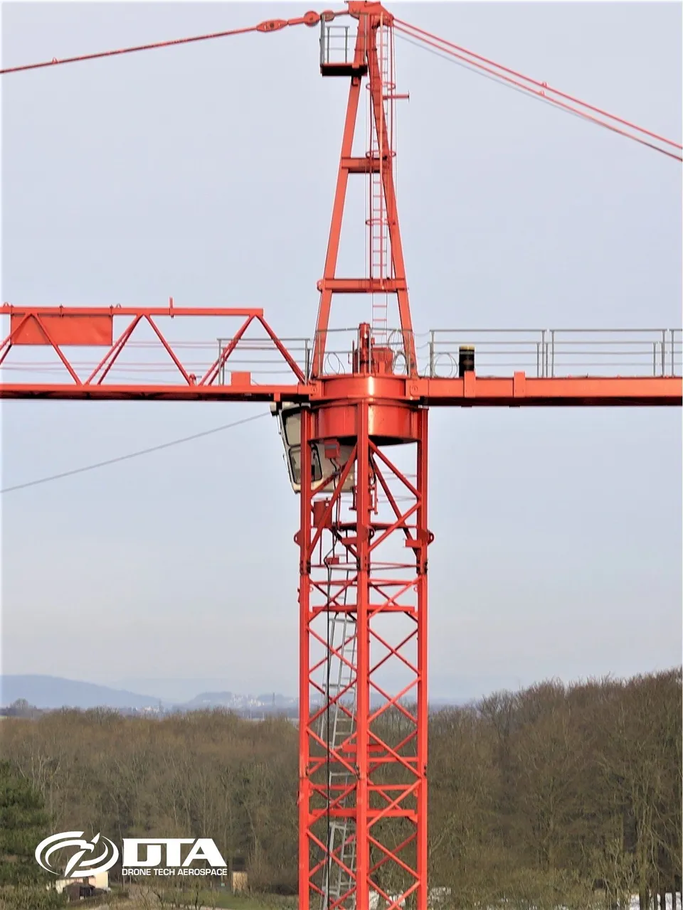 Vertical aerial photograph of a tall construction structure captured during a safety inspection.