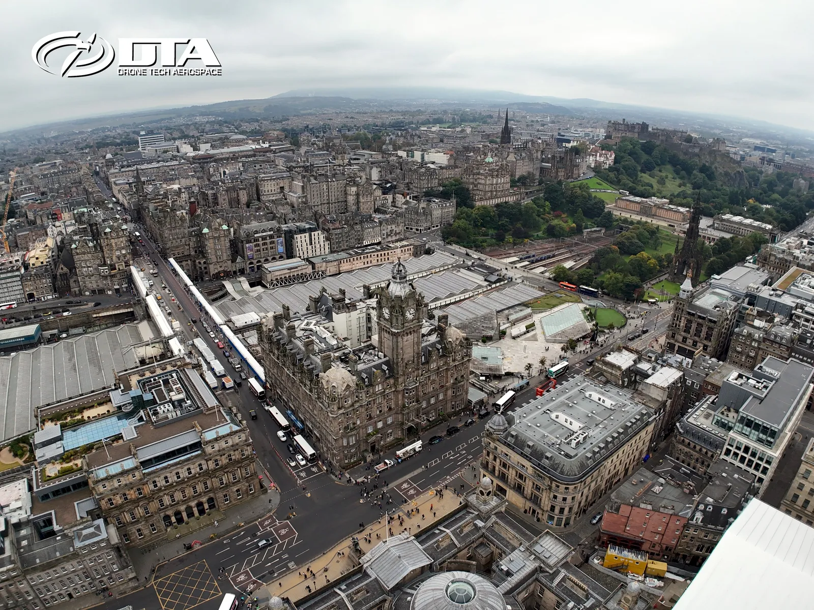 Aerial photograph of tenement rooftops and skyline across central Edinburgh.
