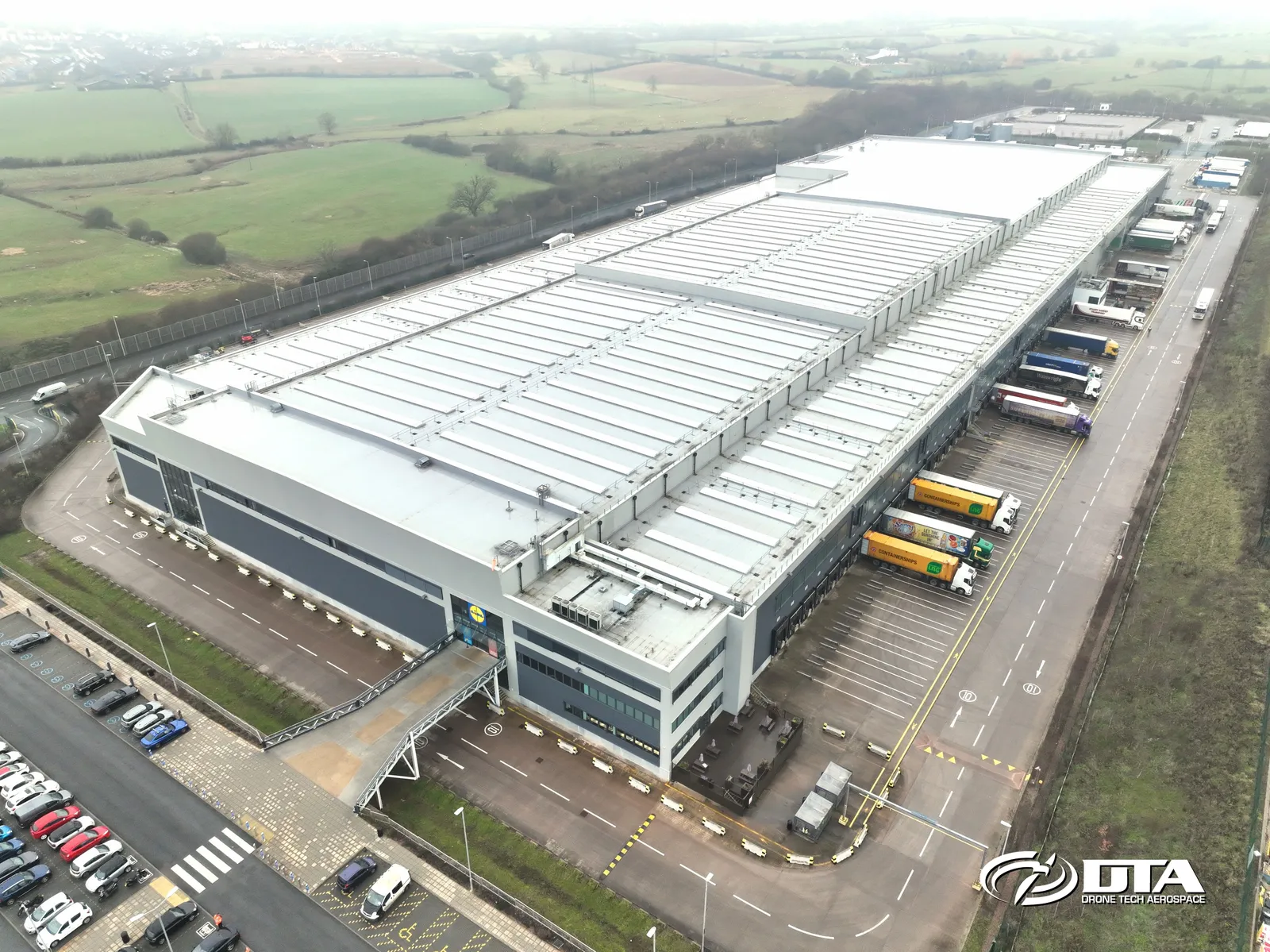 Aerial photograph of a large warehouse roof and yard at a distribution centre in Exeter.
