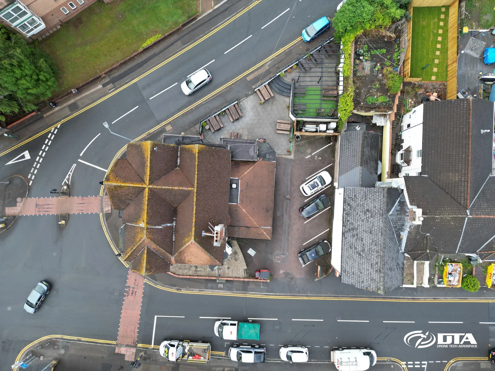 Aerial photograph of a public house building and car park beside a road in Newport.