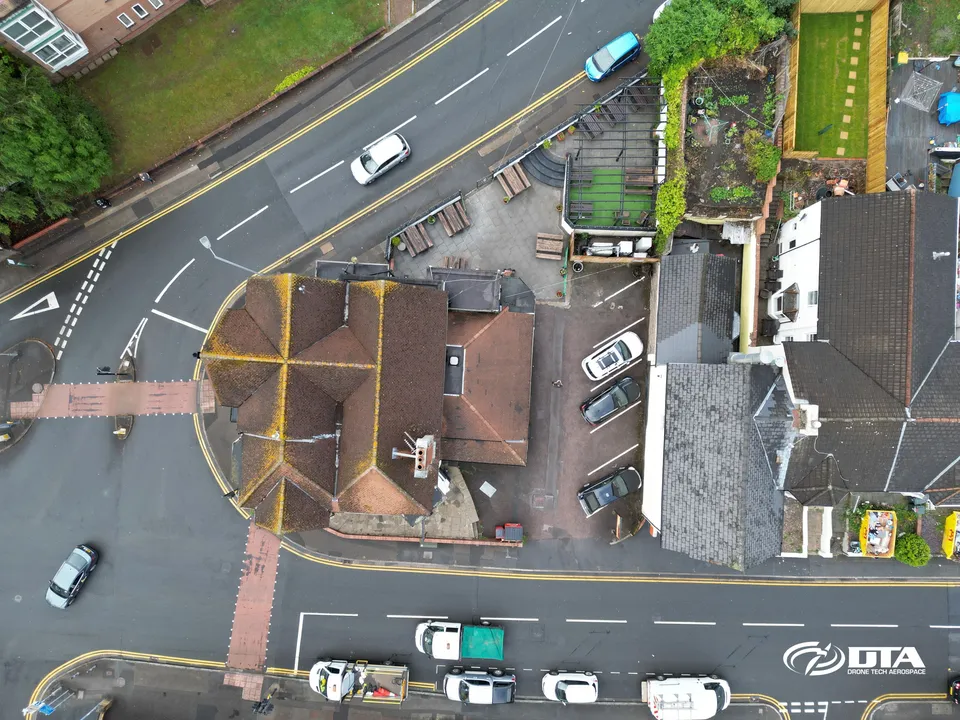 Aerial photograph of a public house building and car park beside a road in Newport.