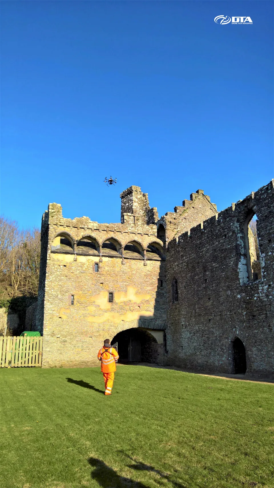 Tall vertical aerial photograph of a heritage building or tower near St Davids captured during a structural inspection.