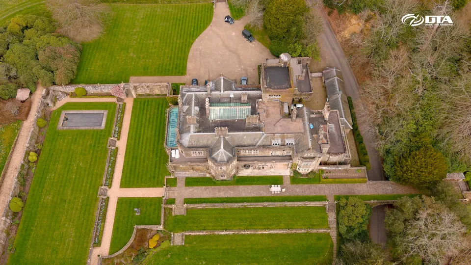 Aerial photograph of a large country house set within an estate with surrounding grounds.