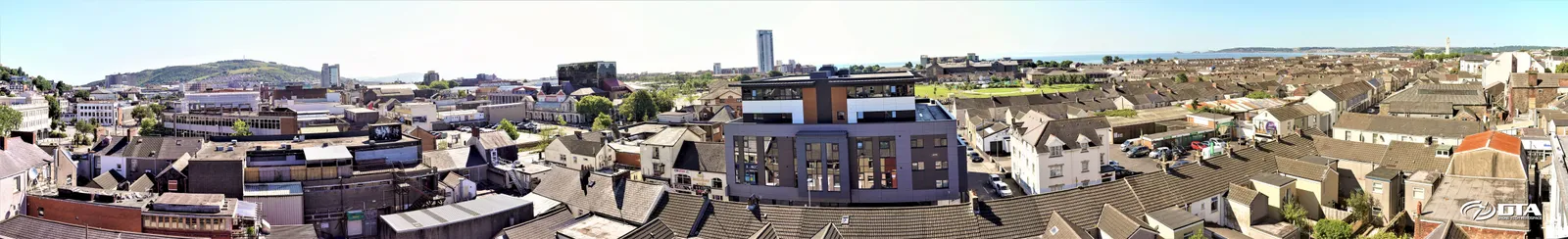 Wide panoramic aerial photograph of a long building elevation in Swansea captured from a MAST-mounted camera.