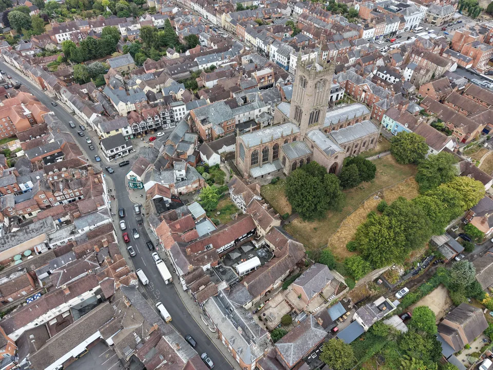 St Laurence's church tower over the roofs of Ludlow town centre, with the Bull Ring and Corve Street to the left.