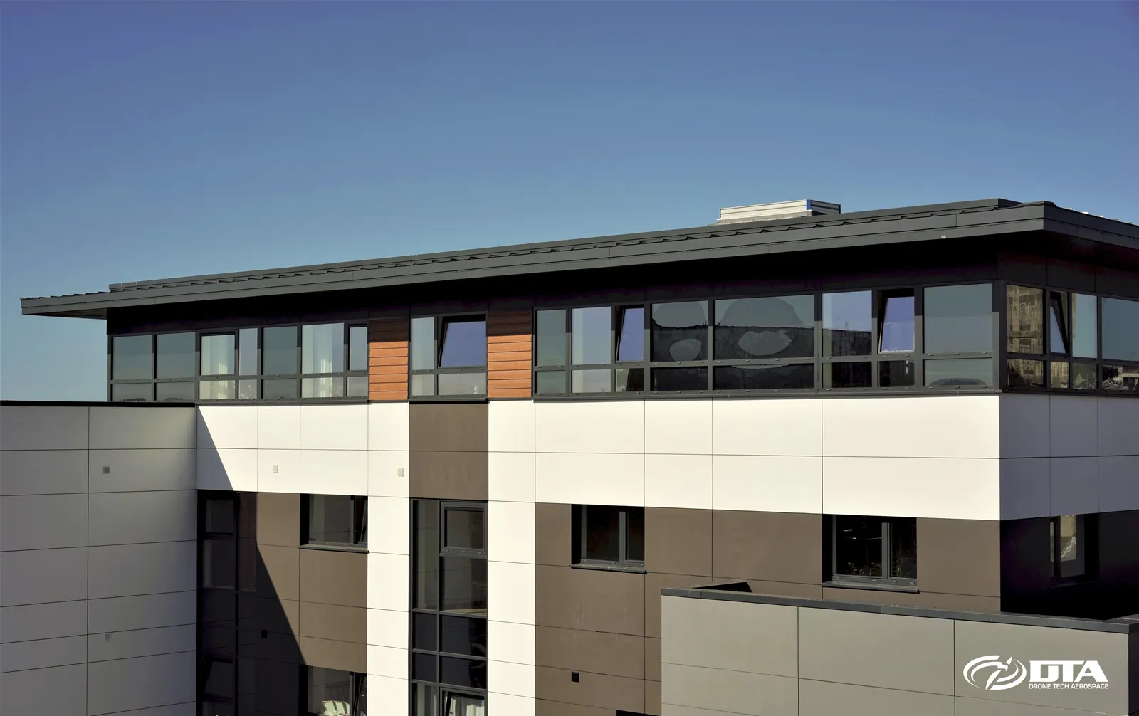 Elevated photograph of a building captured from a 4x4-mounted mast camera rig