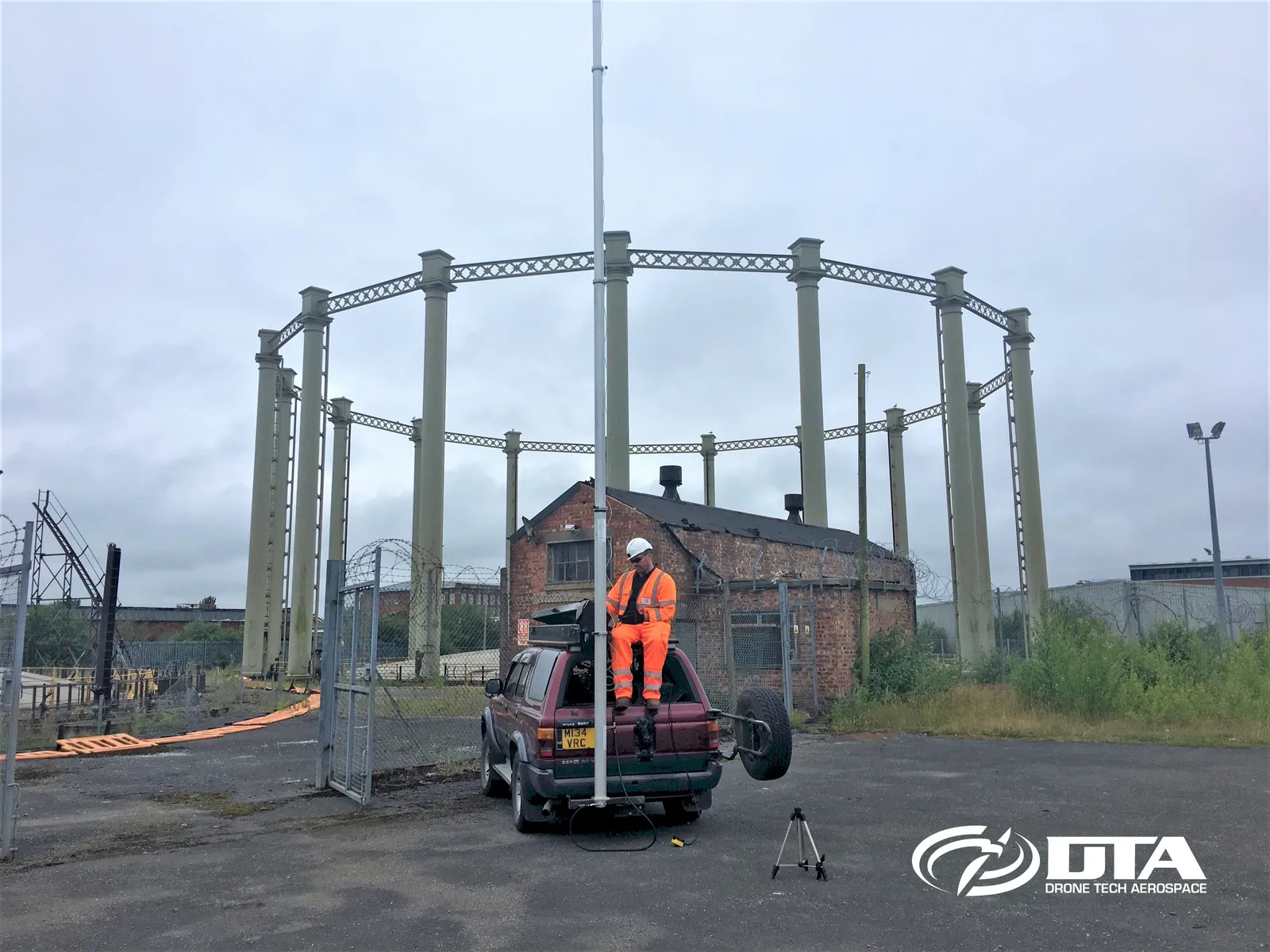 Elevated photograph of an industrial site captured from a mast-mounted camera rig.