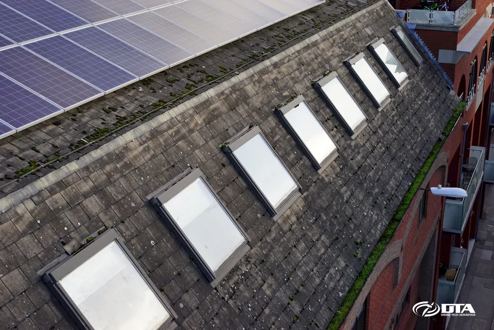 Elevated photograph of a rooftop in a dense inner-city location captured from a mast-mounted camera.