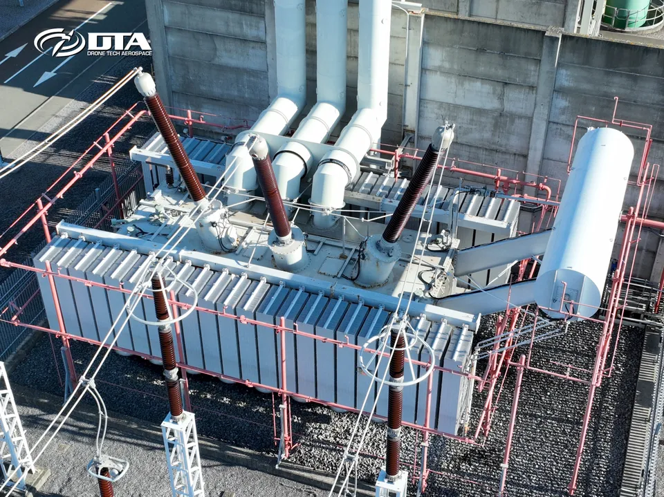 Aerial photograph looking down on transformer units and switchgear at a power station.