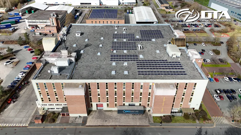 Aerial photograph looking down on an industrial estate near a tower landmark.