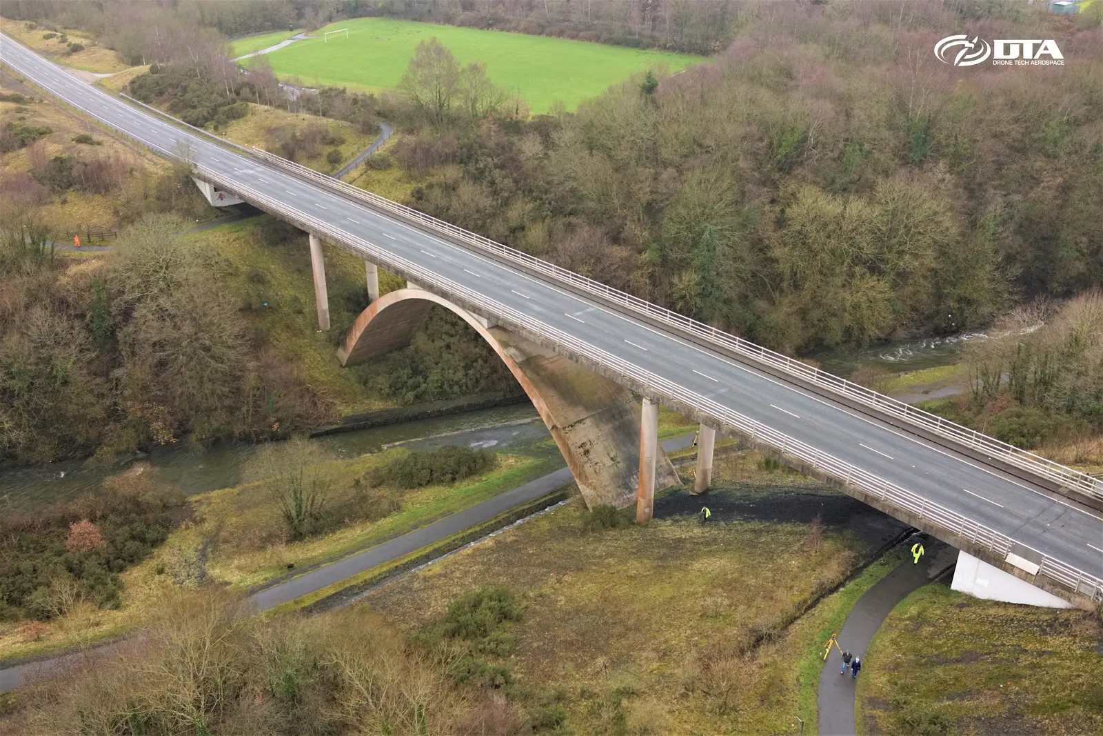 Angled aerial photograph of a road bridge and its stone piers spanning a valley at Rhymney.