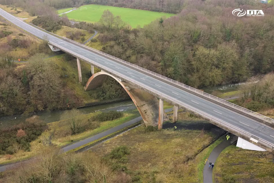 Angled aerial photograph of a road bridge and its stone piers spanning a valley at Rhymney.