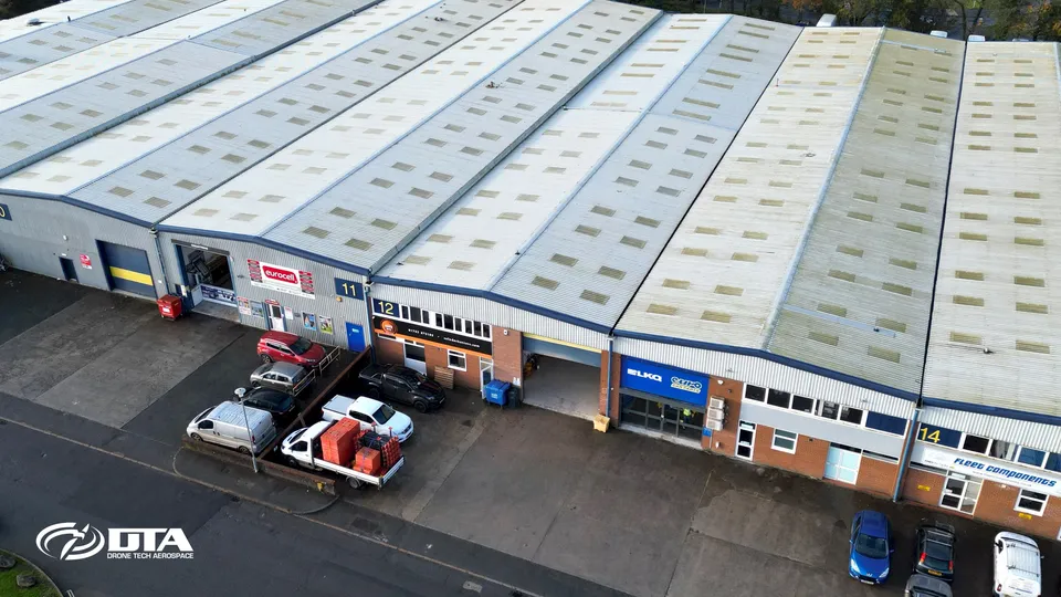 Aerial photograph looking down on an industrial unit roof at a trade park.