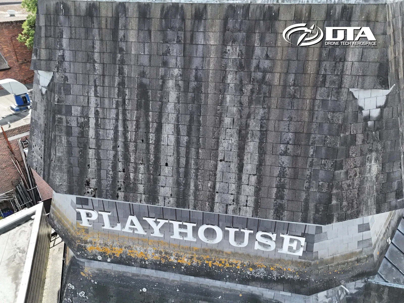 Aerial photograph looking down on a theatre building roof with signage visible at Salisbury Playhouse.