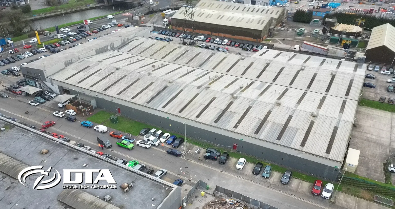 Aerial photograph looking down on a car dealership showroom roof and forecourt at Treforest.