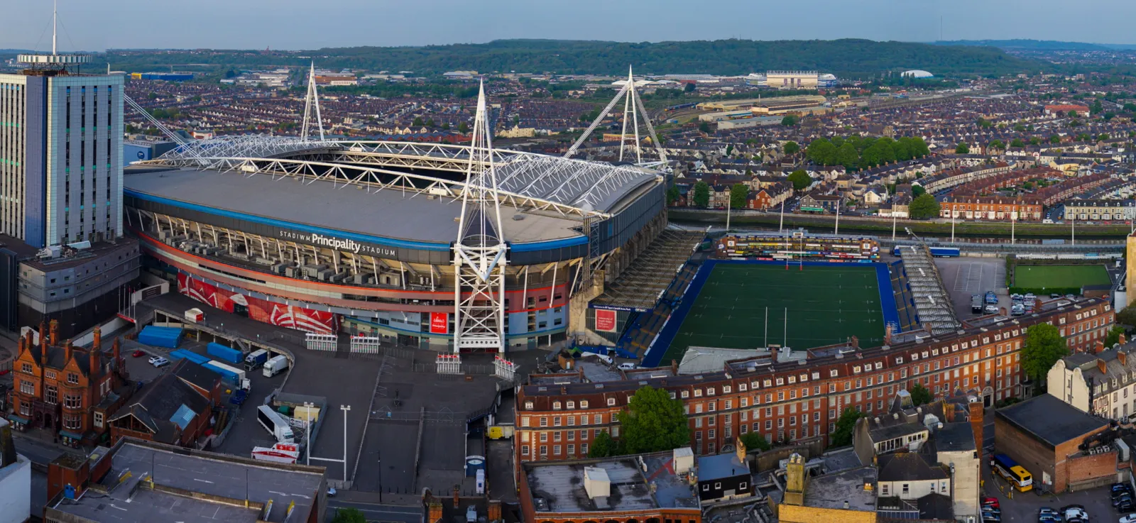 Extremely wide panoramic aerial photograph of a stadium bowl and surrounding car parks.
