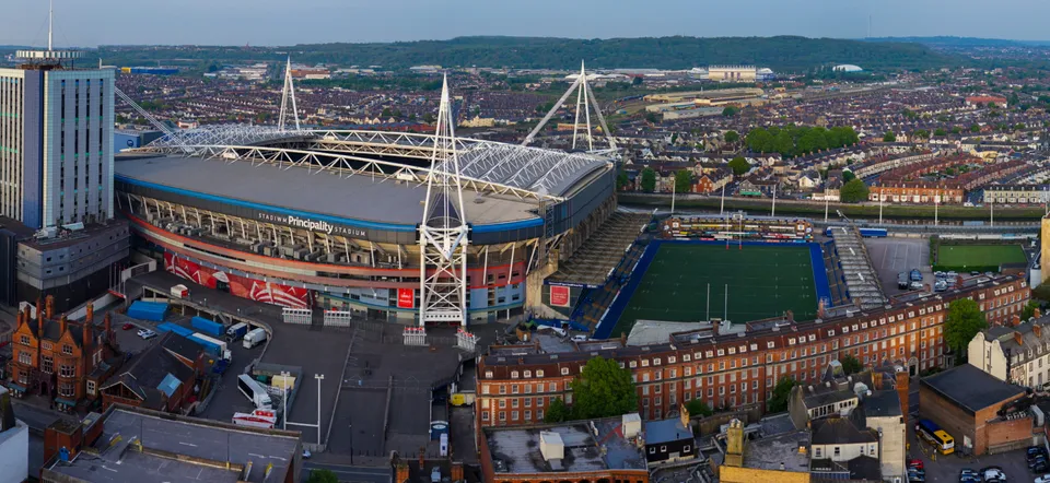 Extremely wide panoramic aerial photograph of a stadium bowl and surrounding car parks.