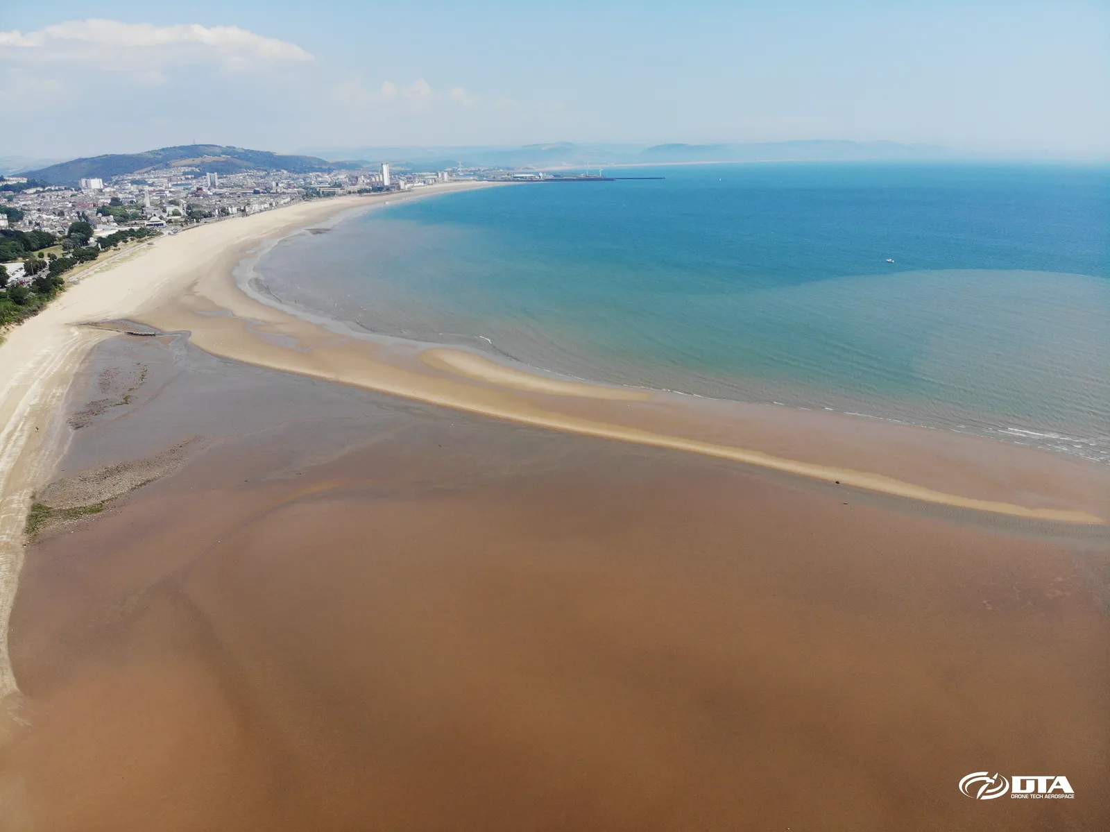 Aerial photograph of a coastline and beach along the eastern side of Swansea Bay.