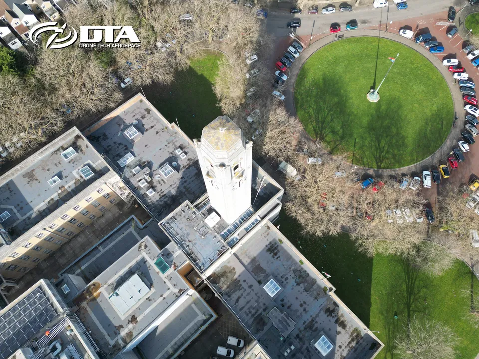 Aerial photograph of the clock face and stonework of Swansea Guildhall's tower from a closer angle.