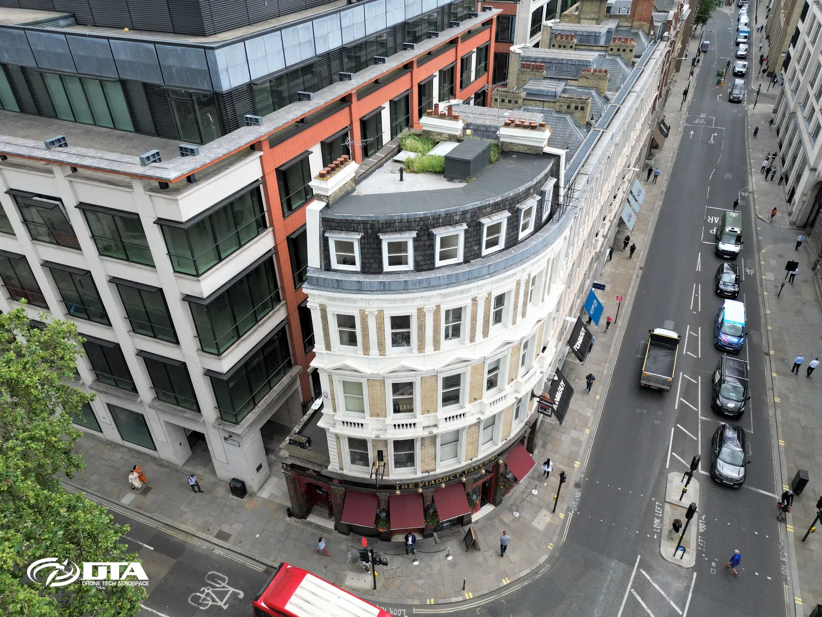 Aerial photograph looking down on the roof and upper facade of a historic public house in the City of London.