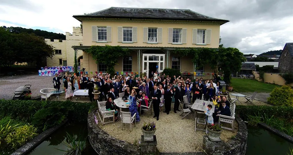 Aerial photograph of a wedding venue and guests captured from a drone.