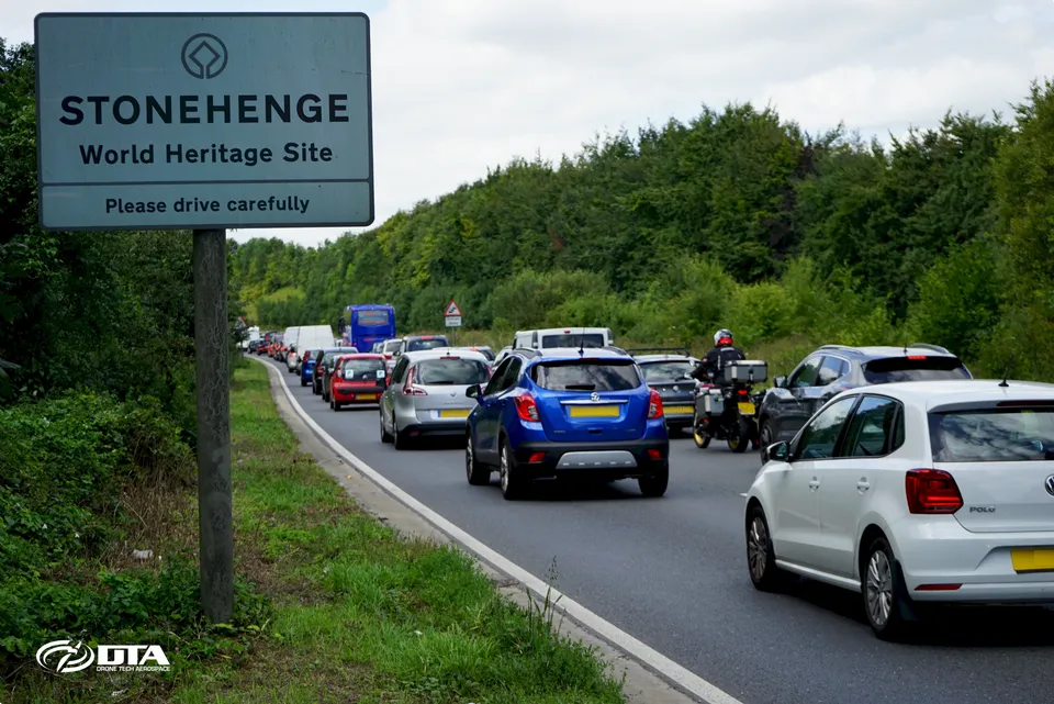 Queuing traffic on the A303 beside the Stonehenge World Heritage Site road sign